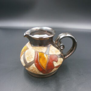 Ceramic art jug, with a unique design and the colours of white / red / yellow / beige